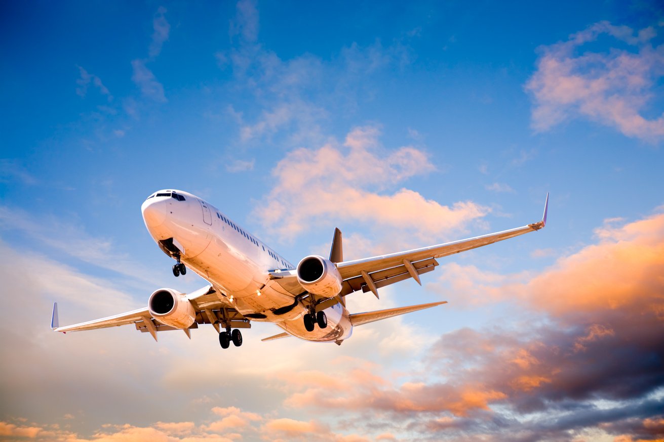 Plane Flying in Sunset Sky